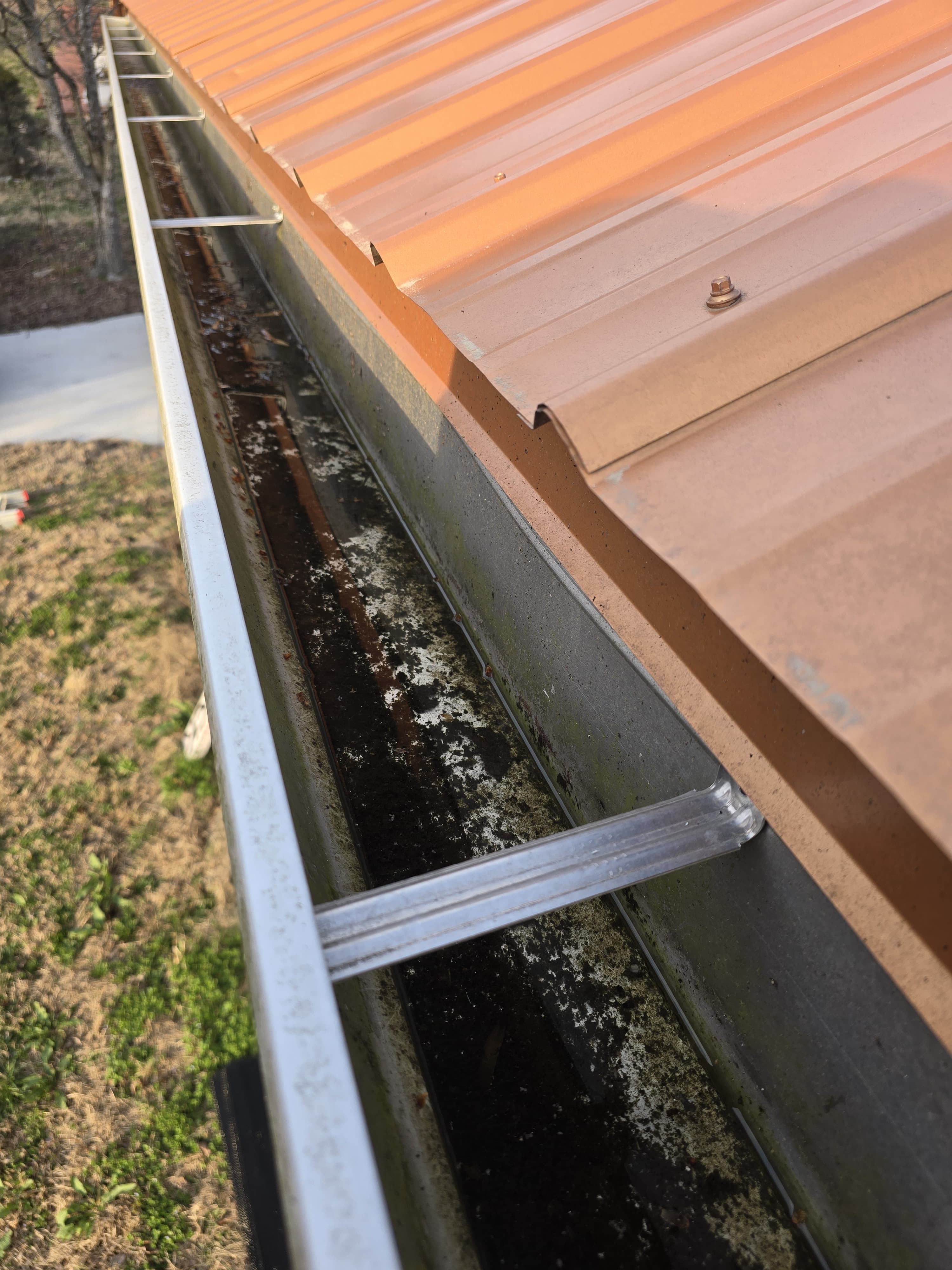 Gutter before cleaning — dirty and corroded